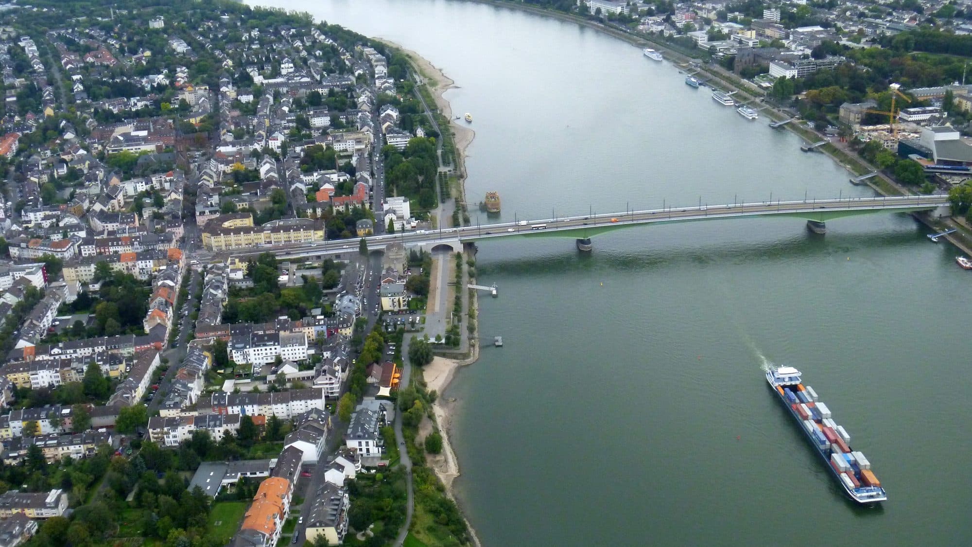 Aerial view of the Rhine at Bonn, with a container barge on the river below the Kennedy Bridge